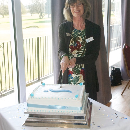 President Diane cutting the celebratory cake